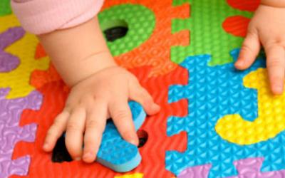 Mani di bambino su tappeto gioco